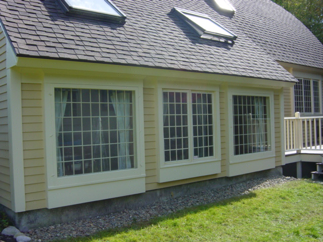 painting services cape cod shows gold salt box home with white trim and big windows with 48 mottins