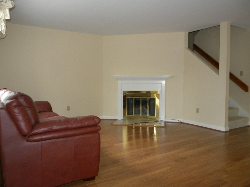 beige room with white wood fire place painted  by a Cape Cod painter