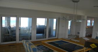 Painting in Cape cod done on the interior of house which is white with crown molding